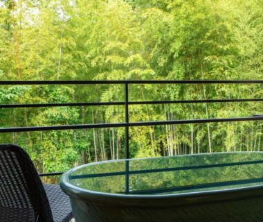 Outdoor bathtub and chair on balcony at Tatsuta Ryokan, Shizuoka, Chūbu, Japan