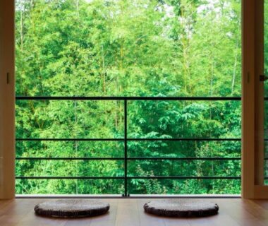 Wooden veranda seating with round cushions at Tatsuta Ryokan overlooking bamboo grove in Shizuoka