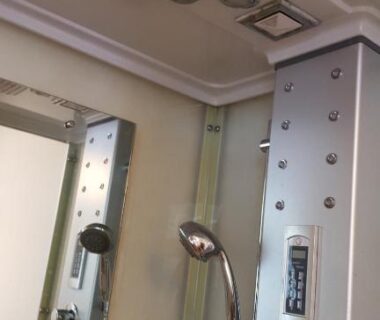 Modern shower panel with handheld head, control knobs and mirror in Tawaraya Ryokan Koto Shirasagikan bathroom, Ōita Kyūshū