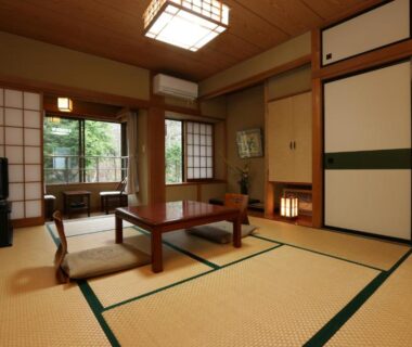 Traditional tatami guest room with low table, shoji screens and garden view at Teiensaryo Yamanakako Yamanashi