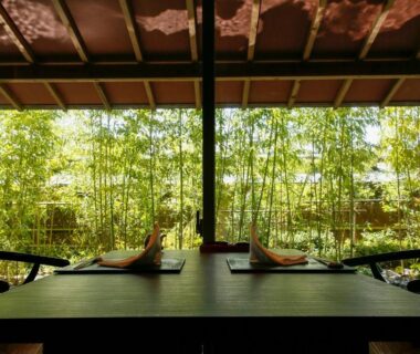 Table set for two facing bamboo garden across open veranda at Teisho Basaratei, Mie