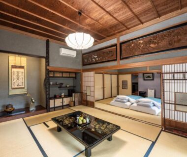 Tatami room with futon bedding, low lacquer table and shoji screens at Temple Lodging Shukubo Kakurinbo, Yamanashi