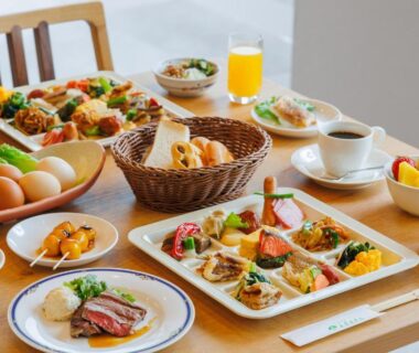 Assorted breakfast dishes on wooden table at Tendo Hotel Yamagata
