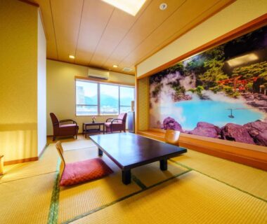 Traditional tatami seating area with low table and mural at Tenku Yubo Seikaiso, Ōita, Kyushu