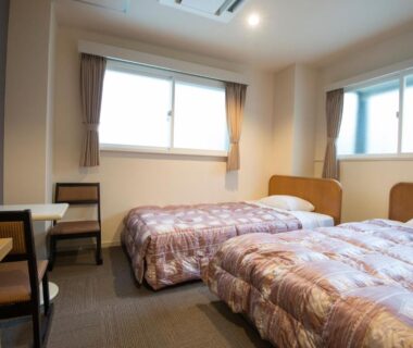 Twin beds, desk, and windows in Tenpyo Ryokan guest room, Nara, Kansai, Japan