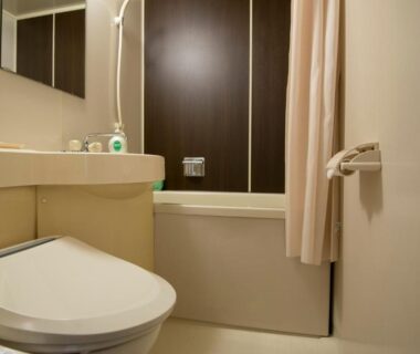Compact bathroom with bathtub, toilet and sink at Tenpyo Ryokan in Nara, Kansai, Japan