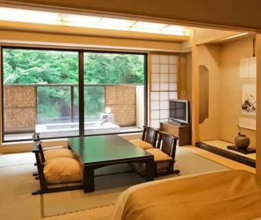Tatami room with low table, shoji screens, twin beds and garden view at Tenseien, Kanagawa