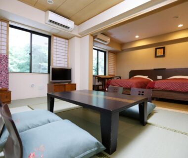 Tatami room with low table, cushions and twin beds at Tenseien in Kanagawa, Kantō, Japan