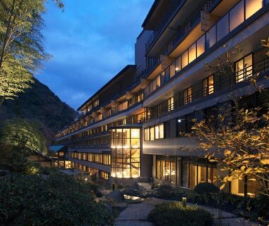 Lit multi-story ryokan beside bamboo and stone path at dusk, Tenseien, Kanagawa, Kantō, Japan