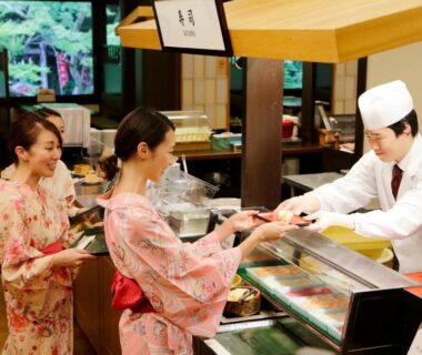 Women in yukata receiving a dish from a chef at counter, Tenseien, Kanagawa Kantō