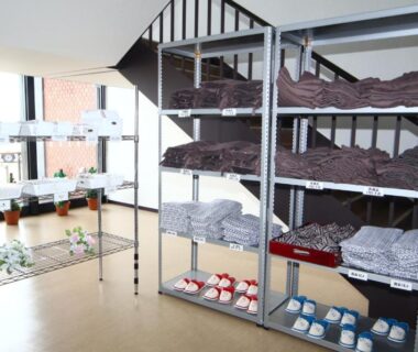 Metal shelving with folded yukata and slippers at Teshio Onsen Yubae, Hokkaidō