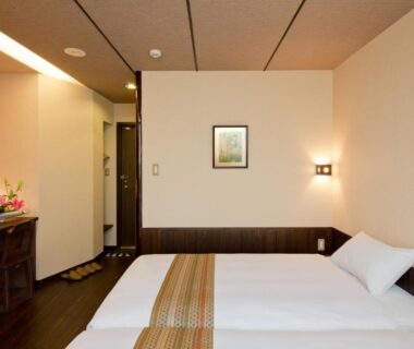 Twin beds in a compact contemporary guest room at The Edo Sakura, Tokyo, Kantō, Japan