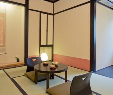 Traditional tatami room with low table, zaisu chairs and tokonoma at The Edo Sakura in Kantō, Tokyo