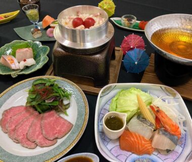 Assorted sashimi, vegetables and hotpot dishes on a table at The Gran Resort Amanohashidate Kyoto