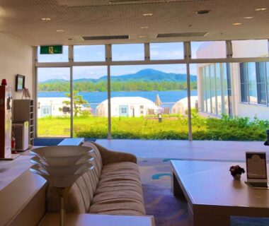 Lounge seating by floor-to-ceiling windows overlooking islands and water at Gran Resort Amanohashidate Kyoto