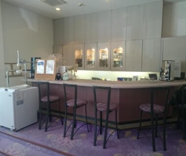 Counter seating with high stools and backlit cabinets at The Gran Resort Arima in Hyōgo Japan