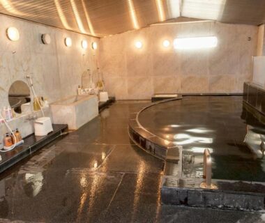 Indoor communal onsen bath with washing stations and mirrors at The Gran Resort Elegante Atami, Shizuoka, Japan