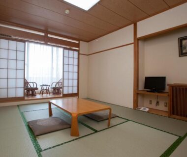 Tatami flooring with low table, floor cushions, shoji screens and window seating at The Gran Resort Elegante Atami in Shizuoka
