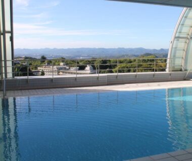 Indoor pool with panoramic glass wall at The Gran Resort Princess Arima in Hyōgo, Kansai