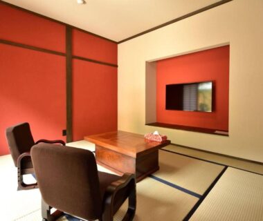 Tatami room with low table and zaisu chairs at The おこもりの宿 夢流し in Gifu Chūbu