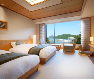 Twin beds in a tatami room with wooden furnishings, shoji screens and bay view at Toba International Hotel Shiojitei Mie