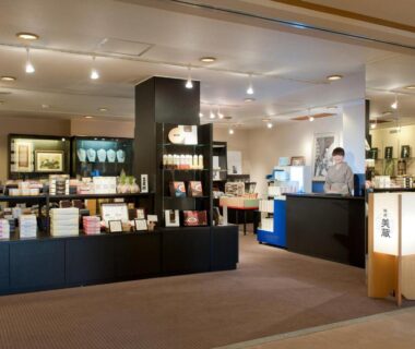 Reception and gift shop area with brochure shelves and check-in desk at Toba International Hotel Shiojitei Mie