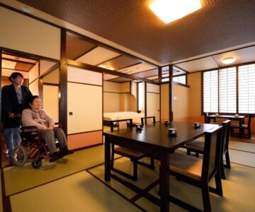 Wheelchair accessible tatami room with dining table and shoji screens at Tofuya Ryokan, Onogawa Onsen, Yamagata