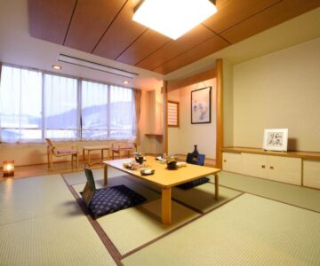Tatami room with low table and floor cushions at Tofuya Ryokan, Onogawa Onsen, Yamagata