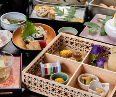 Assorted lacquered dishes and small bowls arranged for a traditional ryokan meal at Togakubo Kanagawa