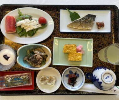 Assorted breakfast dishes including grilled fish and tamagoyaki on lacquer tray at Togawaso, Yamanashi