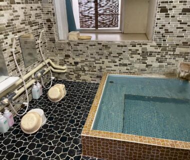 Compact tiled indoor onsen with wash stools at Togawaso Yamanashi