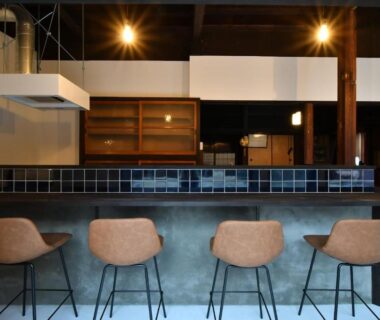 Tiled bar counter with four stools and pendant lights at Togiso 能登の古民家宿, Ishikawa, Chūbu, Japan