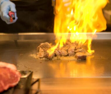 Chef searing beef on teppanyaki grill with flame at Tokachi Makubetsu Onsen Grandvrio Hotel Hokkaidō