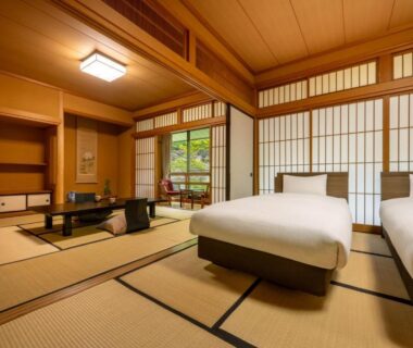 Traditional tatami room with twin beds, low table, shoji screens and garden view at Tokinenoyado Yunushi Ichijoh Miyagi Tōhoku