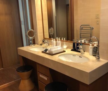 Twin sink vanity with mirrors, wooden stools, toiletries and towel rack at Tokinenoyado Yunushi Ichijoh Miyagi
