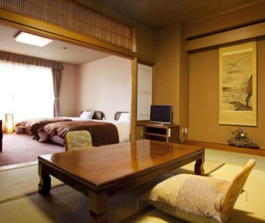 Tatami room with low table and beds at Tokinenoyado Yunushi Ichijoh in Miyagi, Tōhoku, Japan