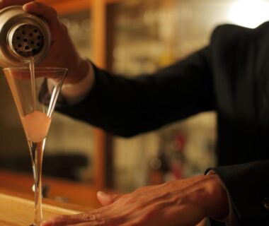 Bartender pouring cocktail into martini glass at Tokinenoyado Yunushi Ichijoh bar in Miyagi Tōhoku