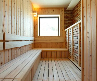 Wood-paneled sauna with benches and heater at Tokinoniwa ryokan in Gunma, Kantō, Japan