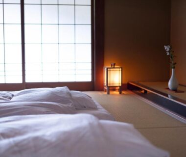 Traditional tatami room with futon bedding, shoji screens and soft lantern lighting at Tokiwa Bekkan, Hyōgo