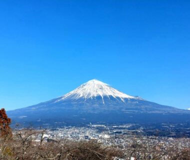 Snow-capped Mount Fuji rising above town near Tokiwa Hotel in Yamanashi, Chūbu