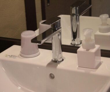 White ceramic sink with chrome faucet and soap dispensers in Tokiwa Ryokan bathroom, Tochigi, Kantō, Japan