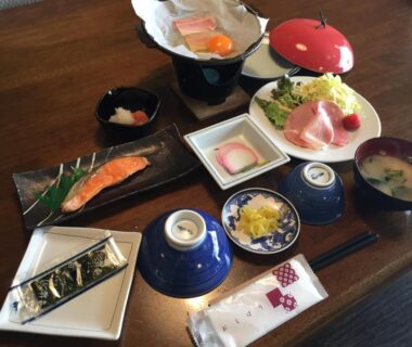 Traditional Japanese breakfast with grilled salmon, rice, miso soup and small side dishes at Tokiwa Ryokan Tochigi
