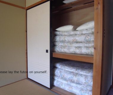 Folded futons stored in closet of tatami room at Tokonamiso in Nagano