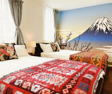 Twin beds with colorful blankets and Mount Fuji wall mural at Louis House near Ginza Tokyo