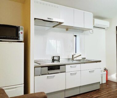 Modern kitchenette with fridge, microwave, stove and sink at Tokyo Private villa Louis House