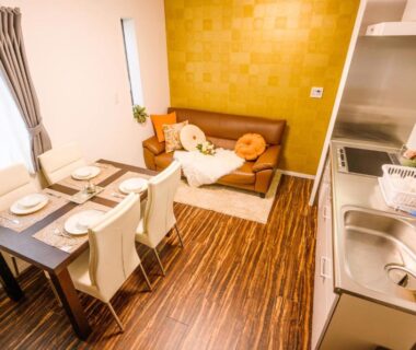 Compact dining area, sofa and kitchenette at Louis House private villa Tokyo