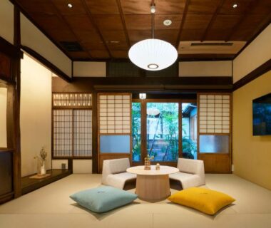 Tatami room with low table, floor cushions and shoji screens at Tomonoura Shiomachi Hotel, Chūgoku, Hiroshima, Japan