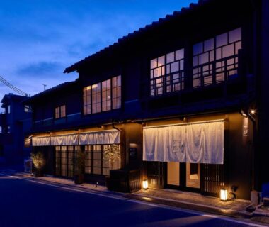 Warm lanternlit wooden facade with noren at Tomonoura Shiomachi Hotel Hiroshima