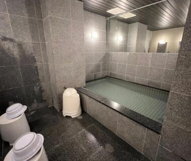 Tiled indoor onsen bath with stools at Towa Ryokan in Kyoto, Kansai, Japan