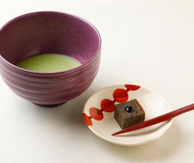 Matcha tea bowl with wagashi and red pick at Towa Ryokan Kyoto